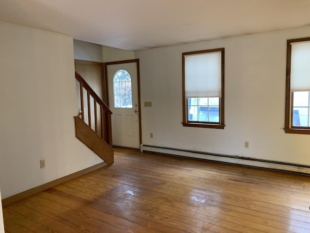 255 Massasoit Rd, Eastham, MA 02642 - foyer with baseboard heating, stairs, hardwood / wood-style flooring, and baseboards