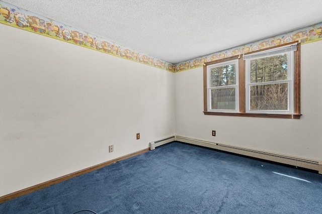 carpeted empty room featuring baseboards, baseboard heating, and a textured ceiling