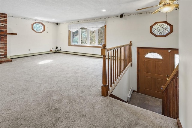 carpeted entryway with recessed lighting, baseboards, a textured ceiling, and a ceiling fan