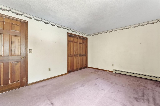 empty room with a textured ceiling, baseboards, baseboard heating, and carpet floors