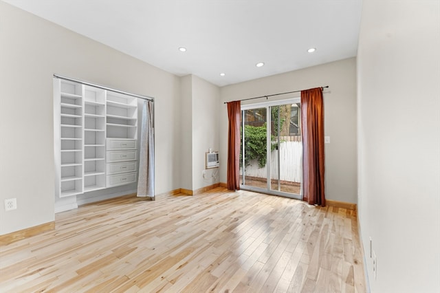 empty room with light hardwood / wood-style flooring