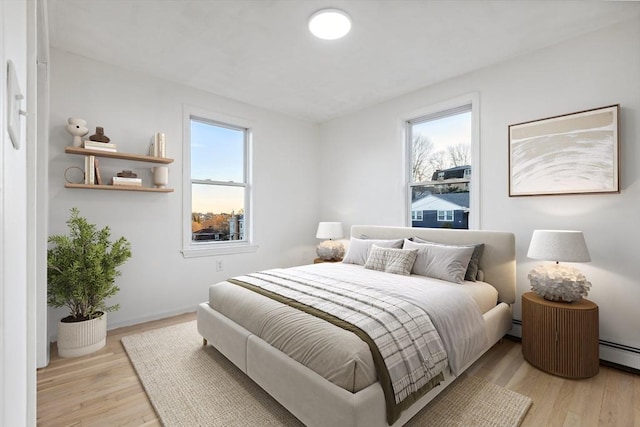 bedroom featuring light wood-type flooring and multiple windows