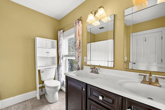 bathroom with toilet, double vanity, baseboards, and tile patterned flooring