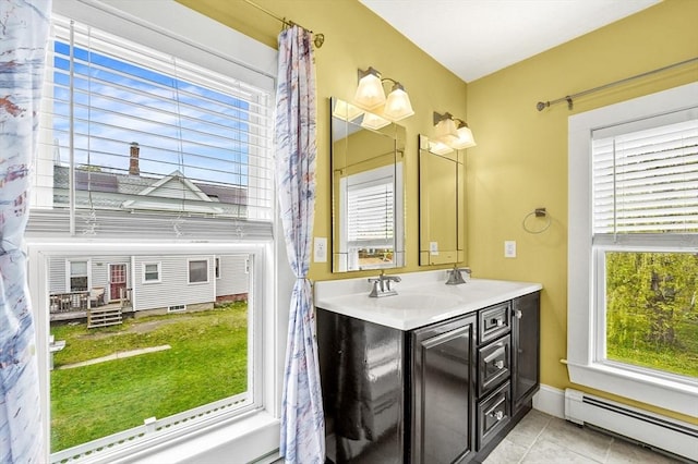 bathroom featuring a baseboard radiator, tile patterned flooring, and double vanity