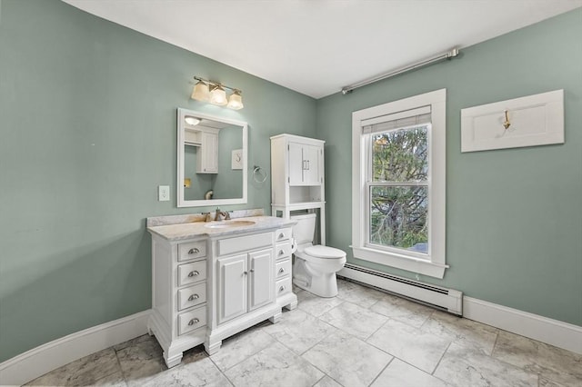 bathroom featuring a baseboard heating unit, marble finish floors, baseboards, toilet, and vanity