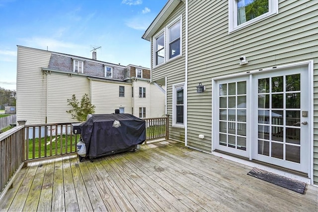 wooden terrace with a grill