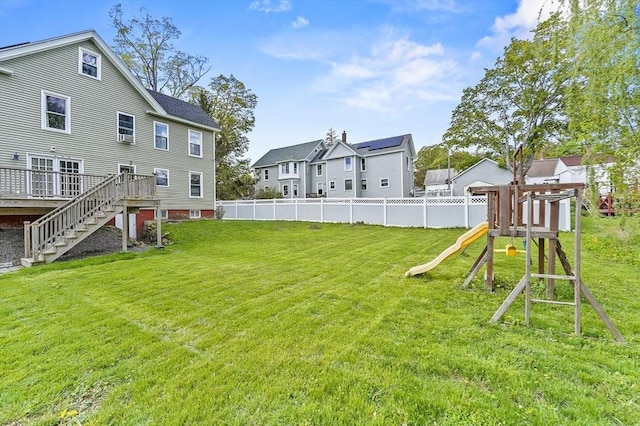 view of yard with a playground, stairs, and a wooden deck