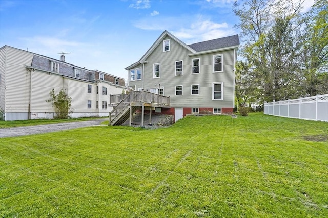 rear view of house with stairs and a wooden deck