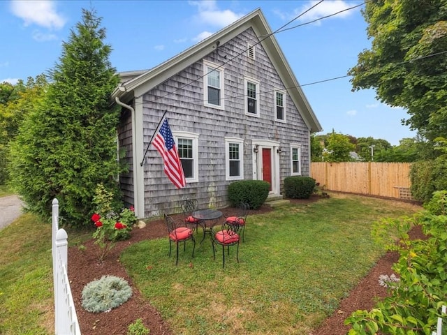 rear view of house with a yard