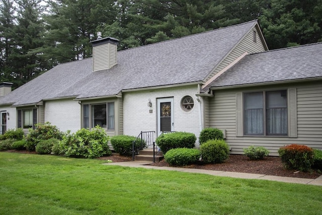 419 Southwick Rd Unit A3, Westfield, MA 01085 - view of front of house with a chimney, a front yard, roof with shingles, and brick siding