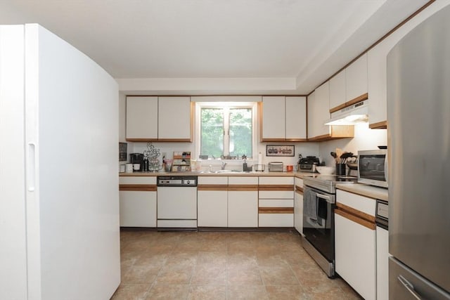 419 Southwick Rd Unit A3, Westfield, MA 01085 - kitchen with appliances with stainless steel finishes, light countertops, under cabinet range hood, and white cabinetry
