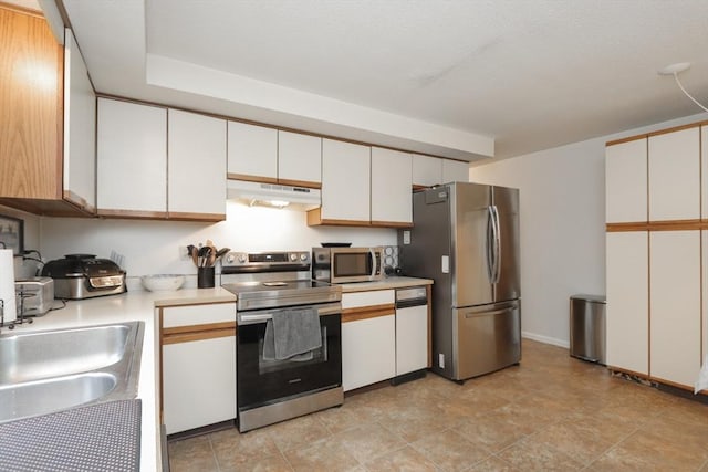 419 Southwick Rd Unit A3, Westfield, MA 01085 - kitchen featuring stainless steel appliances, under cabinet range hood, light countertops, and white cabinetry