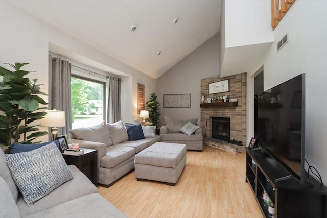 419 Southwick Rd Unit A3, Westfield, MA 01085 - living room with high vaulted ceiling, light wood-style flooring, and a large fireplace