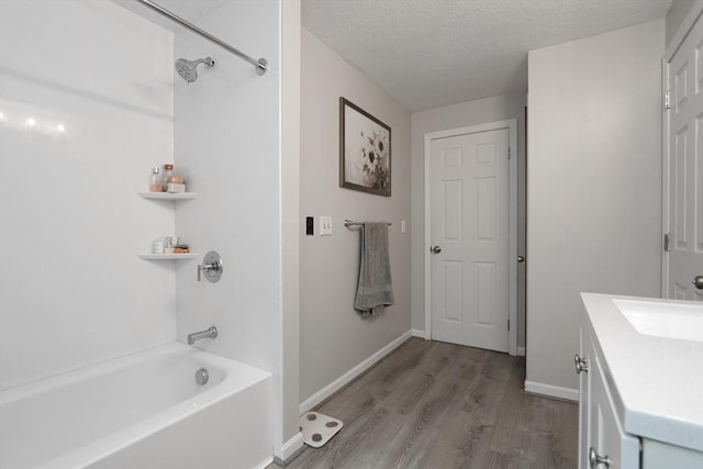 419 Southwick Rd Unit A3, Westfield, MA 01085 - bathroom with vanity, wood finished floors, washtub / shower combination, and a textured ceiling