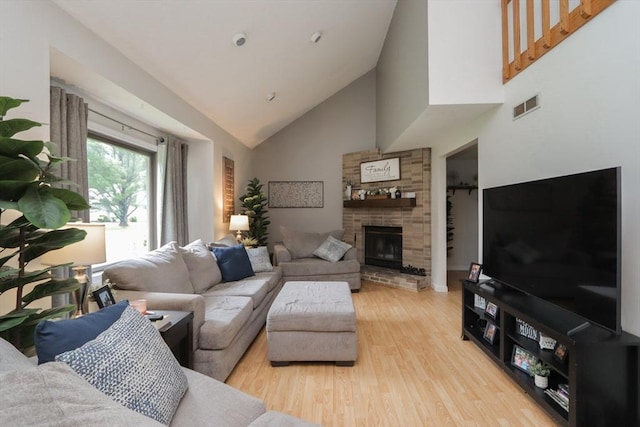 419 Southwick Rd Unit A3, Westfield, MA 01085 - living room with high vaulted ceiling, light wood finished floors, and a fireplace with raised hearth