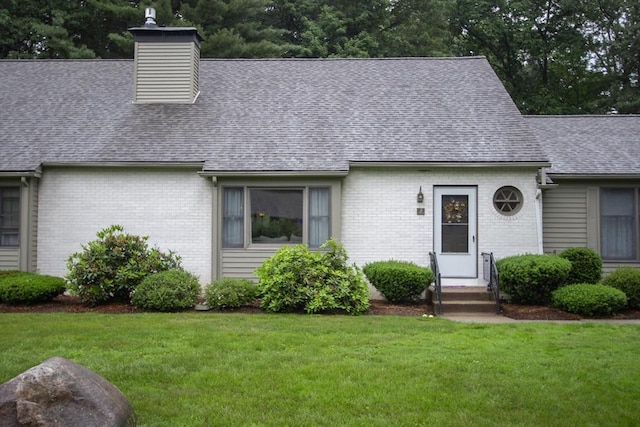 419 Southwick Rd Unit A3, Westfield, MA 01085 - cape cod house featuring roof with shingles, a front yard, brick siding, and a chimney