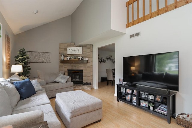 419 Southwick Rd Unit A3, Westfield, MA 01085 - living room featuring high vaulted ceiling, wood finished floors, and a brick fireplace