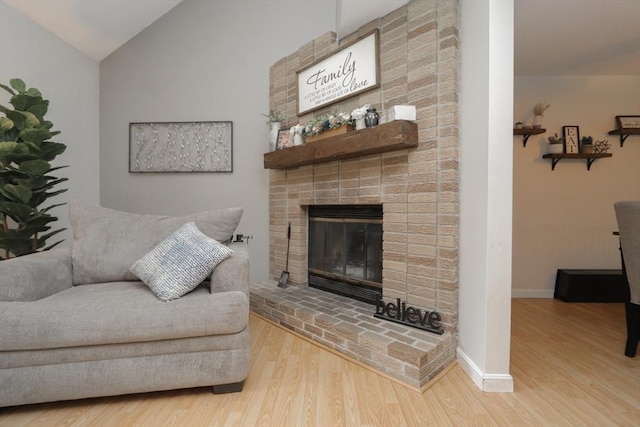 419 Southwick Rd Unit A3, Westfield, MA 01085 - living room with vaulted ceiling, wood finished floors, and a brick fireplace