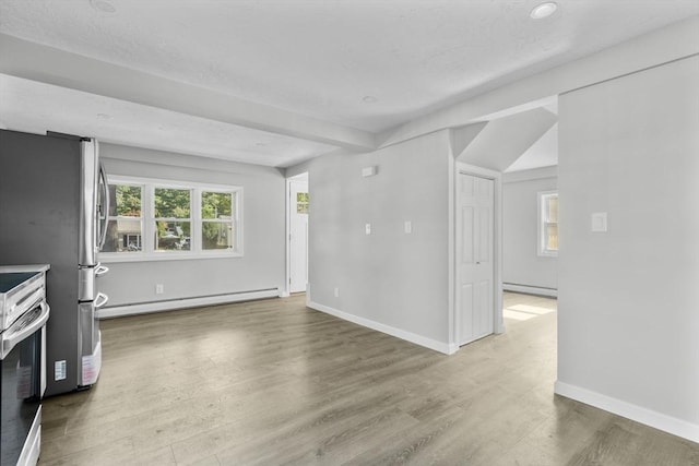 unfurnished living room with a baseboard radiator, wood finished floors, and baseboards