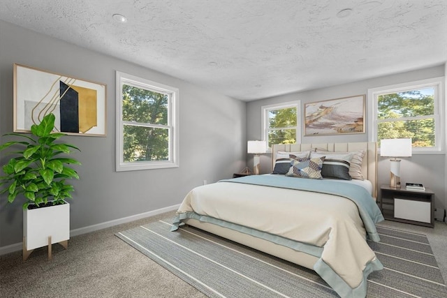 bedroom featuring baseboards, carpet, and a textured ceiling