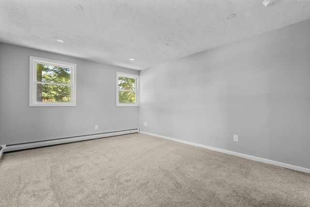 carpeted spare room with recessed lighting, baseboard heating, a textured ceiling, and baseboards