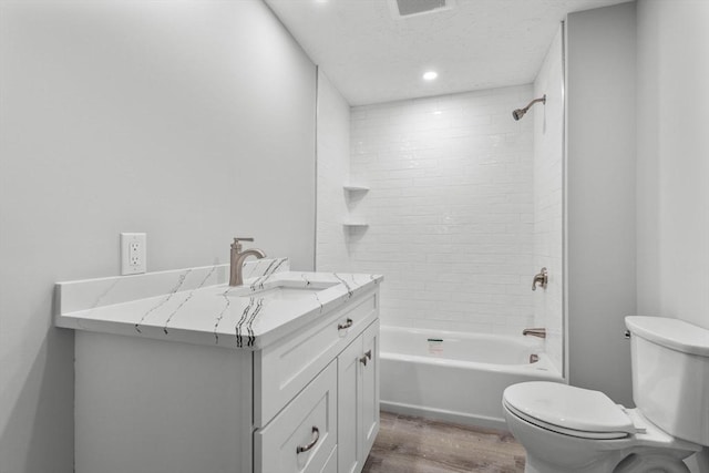 bathroom featuring bathing tub / shower combination, vanity, recessed lighting, toilet, and wood finished floors