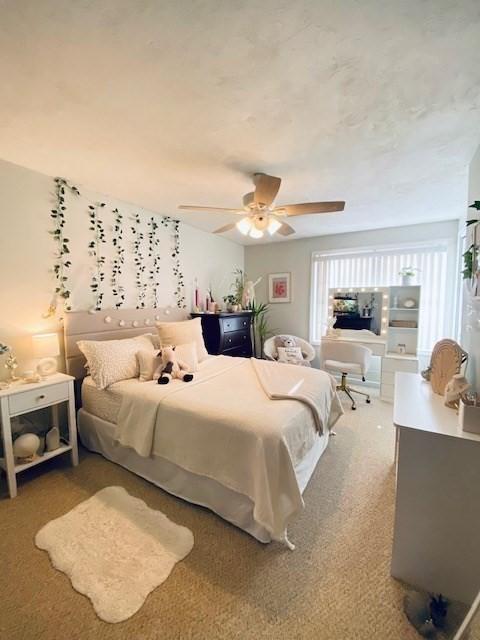 carpeted bedroom featuring ceiling fan