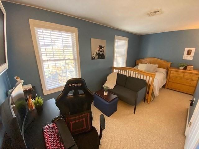 carpeted bedroom with visible vents