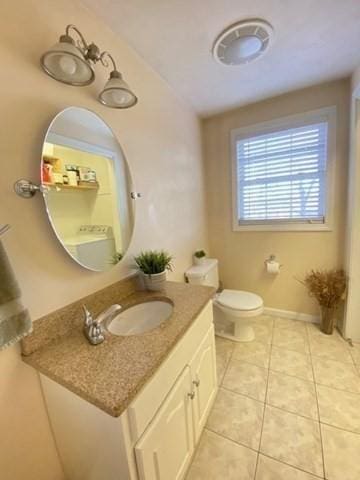 bathroom with toilet, tile patterned flooring, vanity, and baseboards