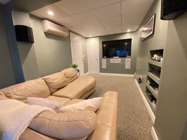 carpeted cinema room with recessed lighting, a wall unit AC, a paneled ceiling, and baseboards