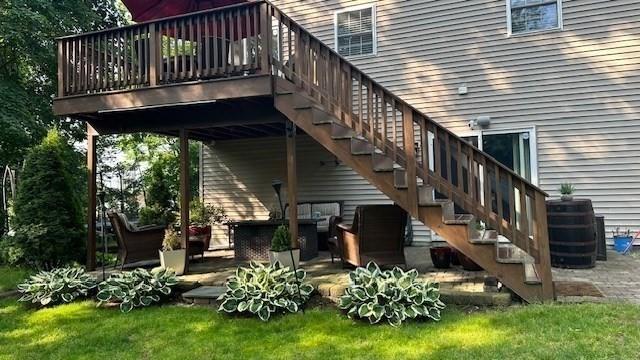 exterior space with a deck, central AC, and stairway