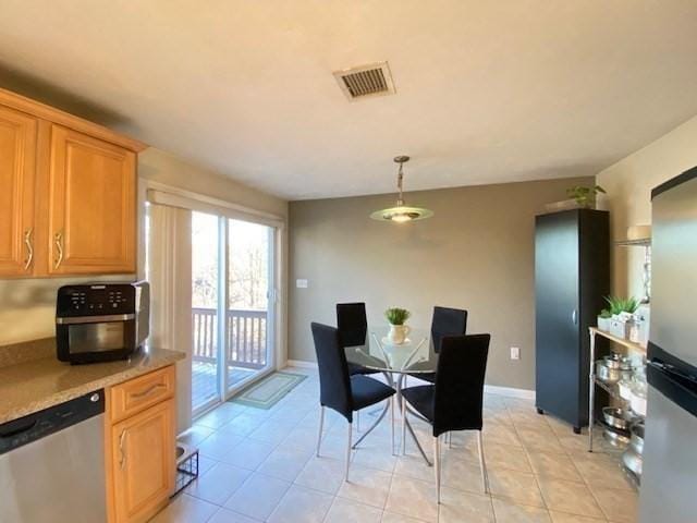 dining space with visible vents, baseboards, and light tile patterned floors