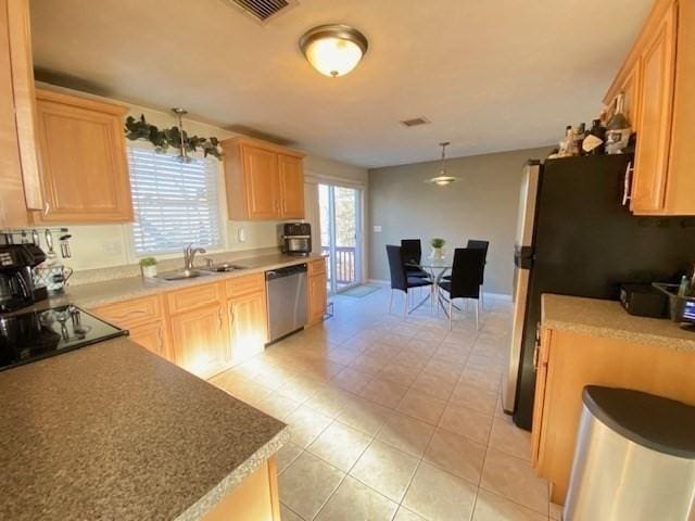 kitchen featuring visible vents, light brown cabinetry, appliances with stainless steel finishes, light tile patterned flooring, and a sink