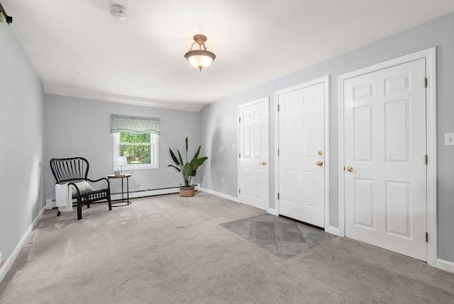 living area featuring carpet floors, baseboards, and a baseboard heating unit