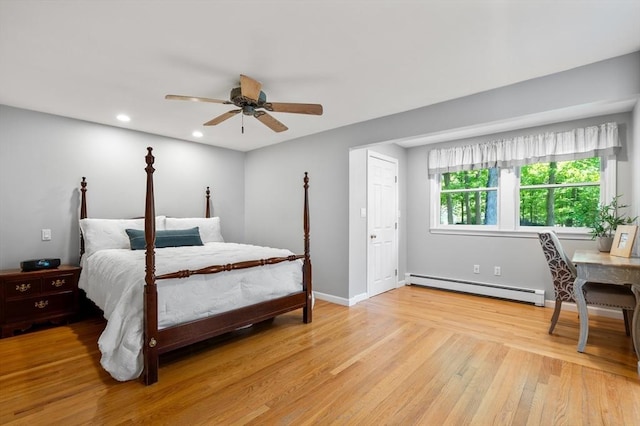 bedroom featuring a baseboard heating unit, light wood-style flooring, recessed lighting, ceiling fan, and baseboards
