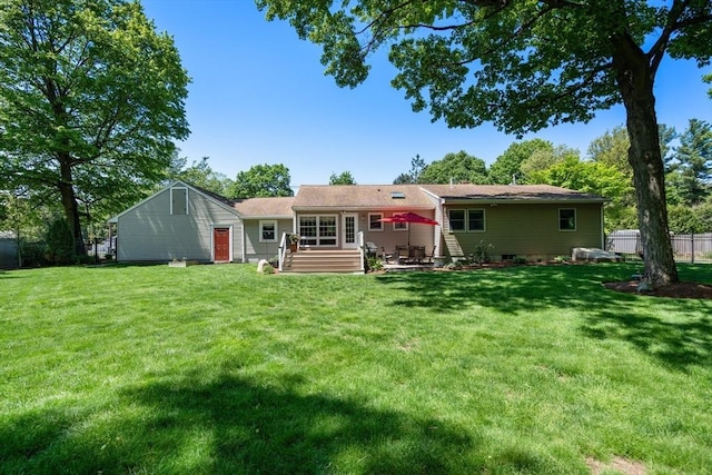 back of property featuring a patio area and a yard