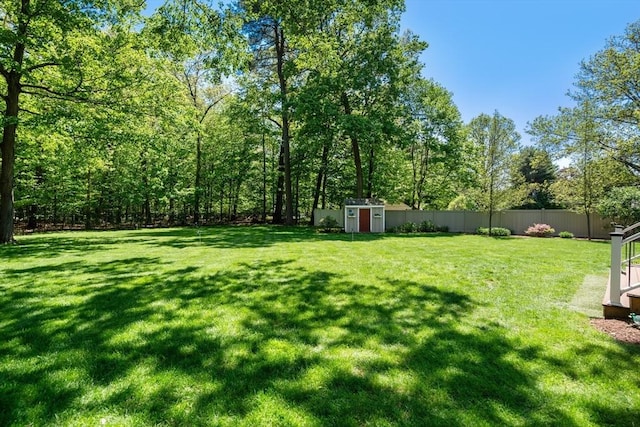 view of yard featuring a storage shed and an outbuilding