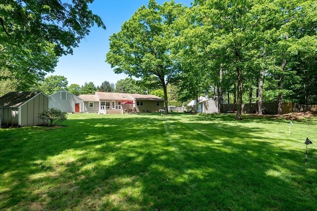 view of yard with a storage shed and an outdoor structure