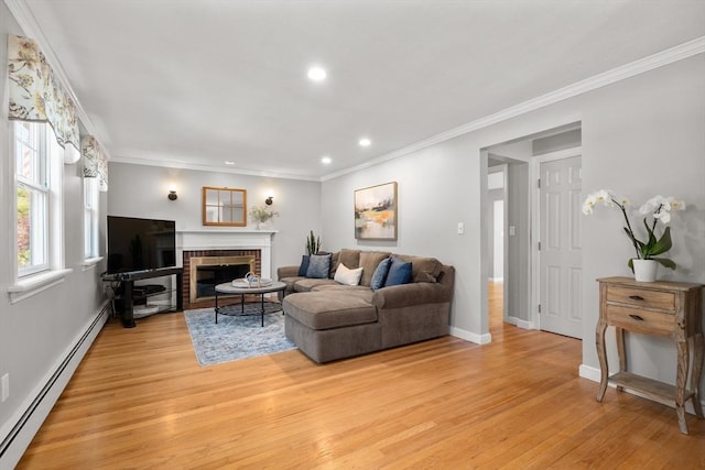 living area with baseboard heating, light wood-style flooring, recessed lighting, a brick fireplace, and ornamental molding