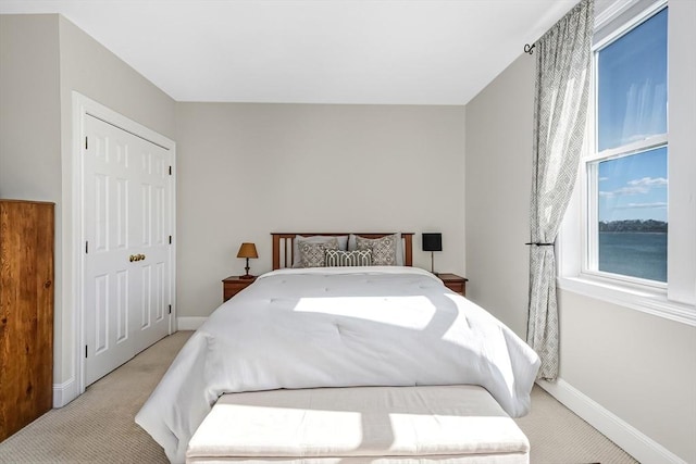 bedroom with light carpet and baseboards