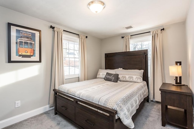 carpeted bedroom featuring multiple windows