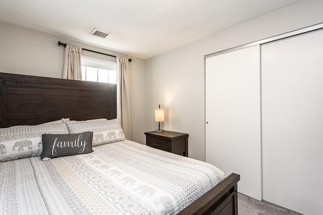 bedroom featuring carpet and a closet