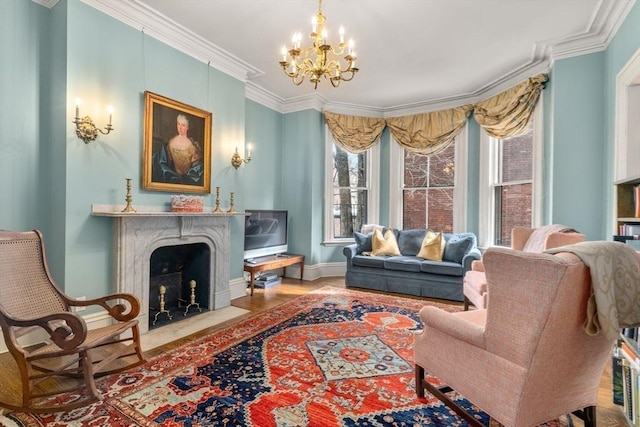 living area with crown molding, a premium fireplace, a wealth of natural light, and a notable chandelier