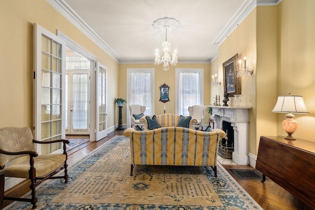 sitting room featuring a fireplace with flush hearth, crown molding, baseboards, and an inviting chandelier