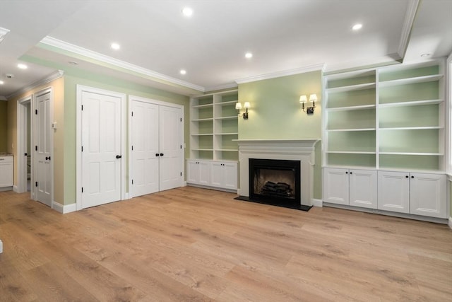 unfurnished living room featuring light wood-type flooring, a fireplace, crown molding, and recessed lighting