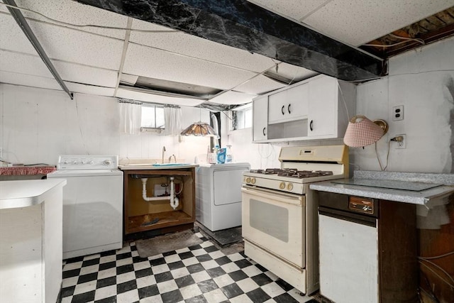 114 Byron St, Boston, MA 02128 - kitchen featuring white gas range, light floors, a paneled ceiling, light countertops, and white cabinetry