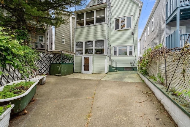 114 Byron St, Boston, MA 02128 - rear view of house featuring a patio and a fenced backyard