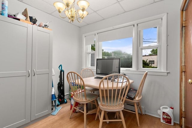 114 Byron St, Boston, MA 02128 - dining area with a chandelier, light wood finished floors, and a baseboard radiator
