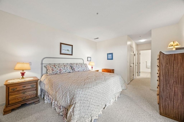 bedroom featuring light carpet