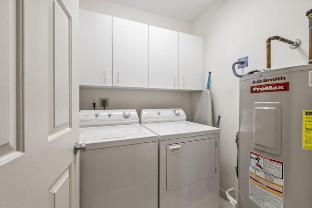 washroom with washer and dryer, cabinets, and electric water heater